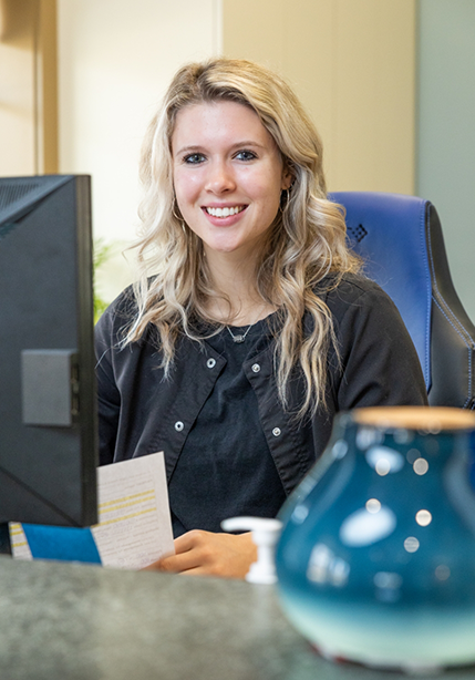Summerfield dental team member sitting behind a desk