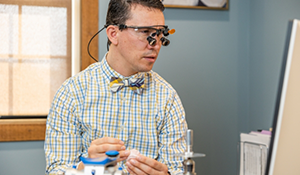 Doctor Parry holding a model of the teeth