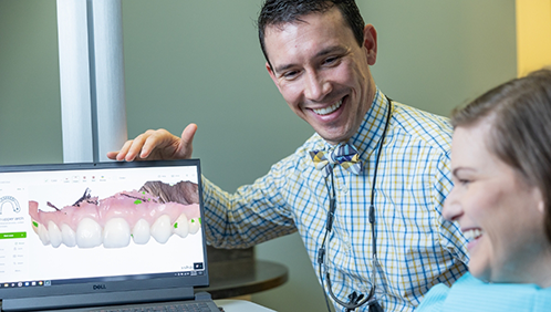 Doctor Parry showing a patient digital impressions of their teeth