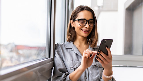 Woman smiling at her phone
