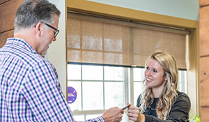Man paying for his dental treatment