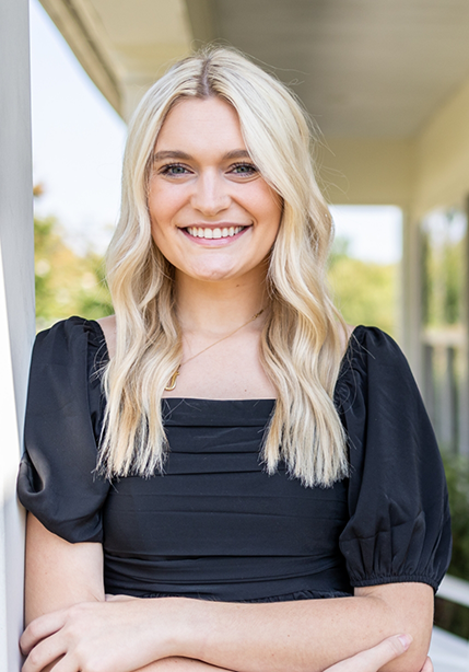 Blonde woman smiling confidently after cosmetic dentistry in Summerfield
