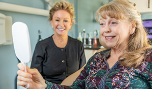 Woman admiring her smile in a mirror