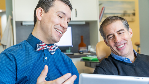 Doctor Parry showing a screen to a patient