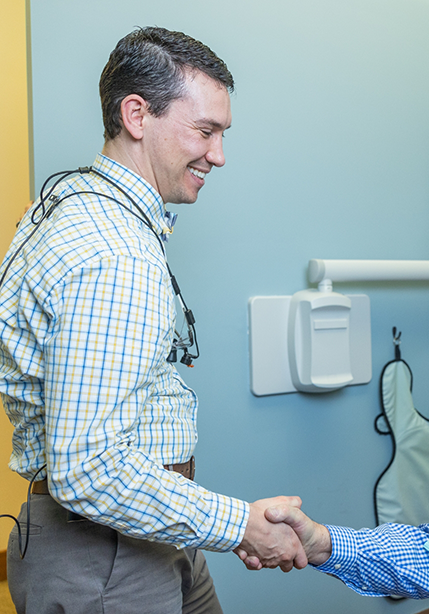 Doctor Parry shaking hands with a patient