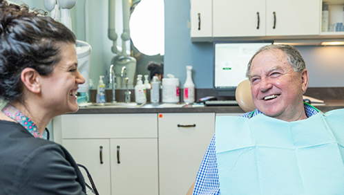 Dental patient laughing with a team member