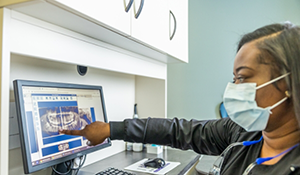 Dental team member looking at x rays of a patient's teeth