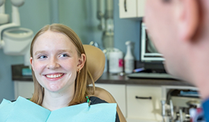 Young woman smiling at her dentist