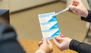 Dental team member showing a pamphlet to a patient