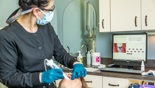 Dental professional taking digital impressions of a patient's teeth