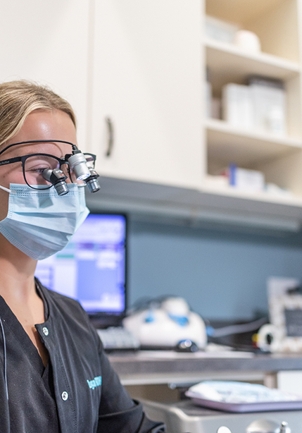 Dental team member helping perform direct bonding on a patient