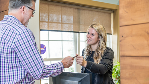 Man paying for his dental treatment