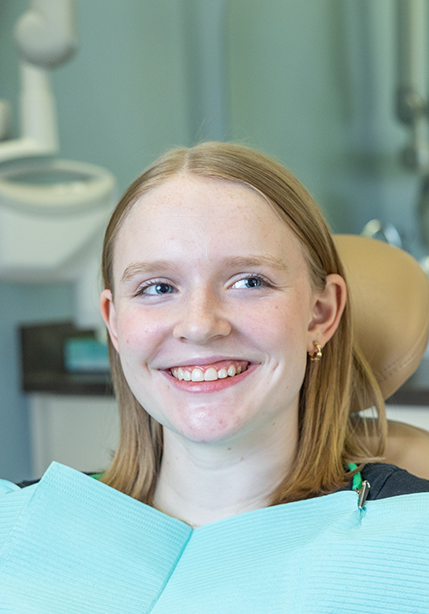 Young woman smiling at her dentist in Summerfield