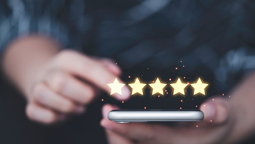 Person leaving a five star review on their phone