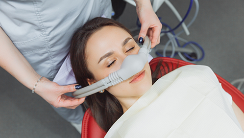Dental patient with a nitrous oxide mask over her nose