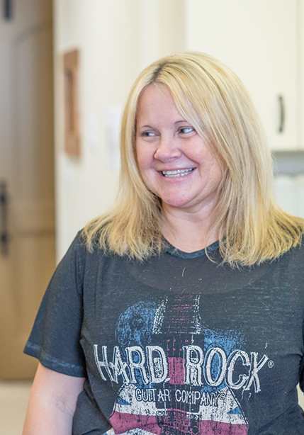 Blonde woman grinning after a smile makeover in Summerfield