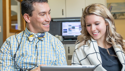 Doctor Parry showing a book to a patient