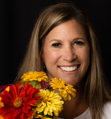 Smiling woman holding a bouquet of flowers