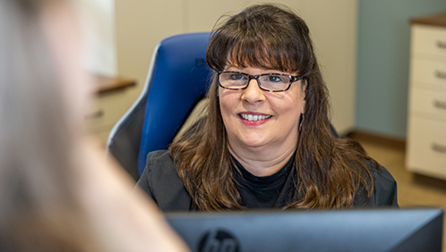 Dental team member talking with a patient