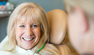 Blonde woman grinning at her dentist