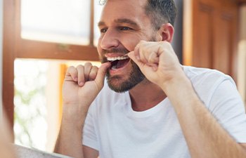 Man flossing his teeth