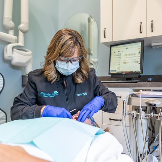 Woman in need of emergency dentistry holding jaw