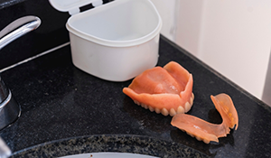 Dentures resting on a sink counter