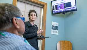 Dental team member showing a patient photos of their teeth